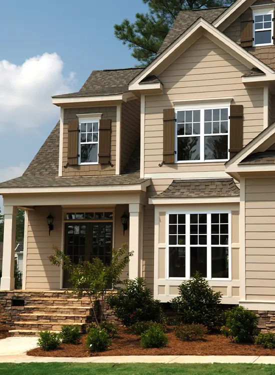 Modern beige home Ottawa with large windows, shutters, and siding