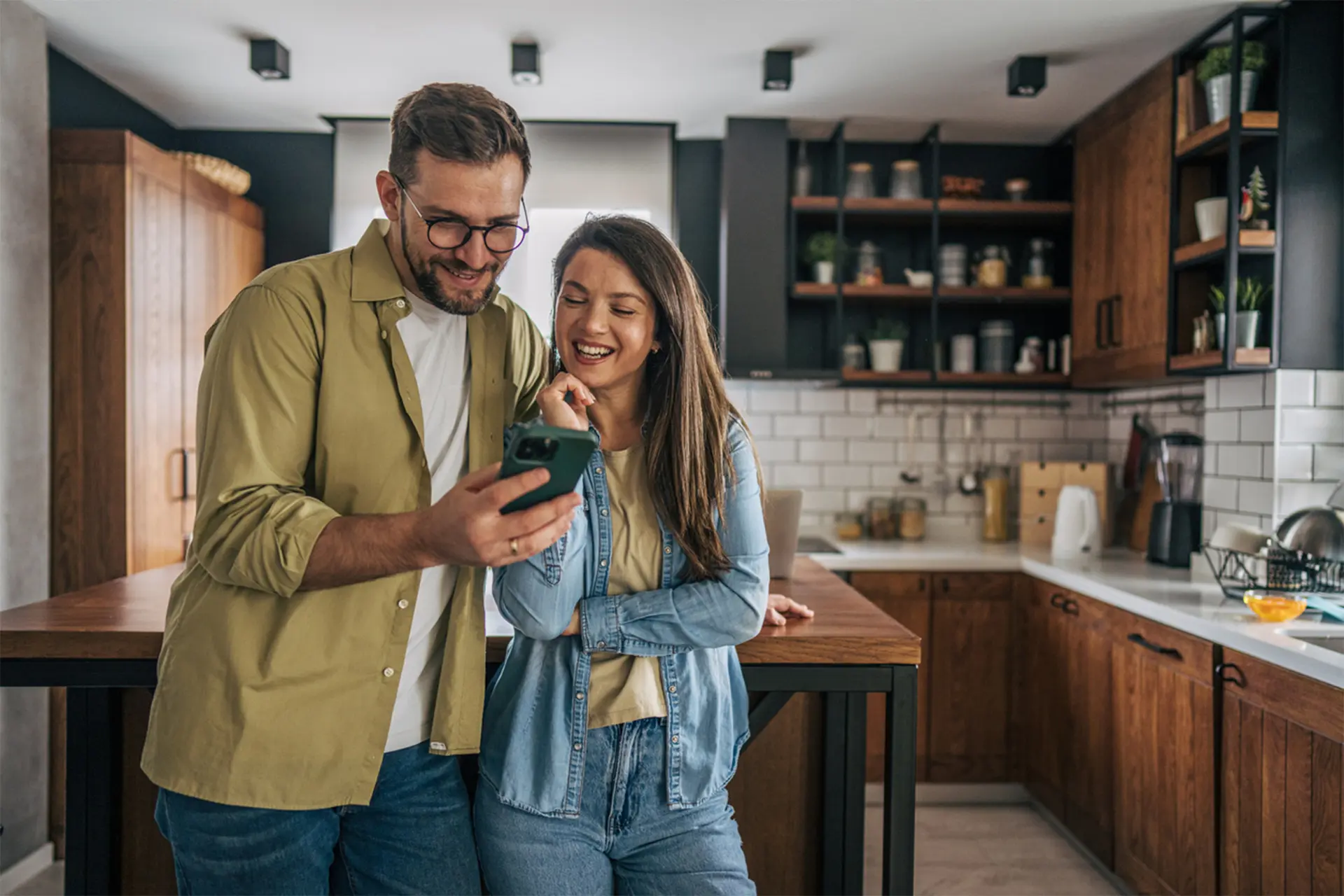 Smiling couple in modern, updated kitchen by BestCan