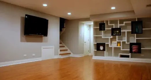 Finished basement with wood flooring and modern shelving unit