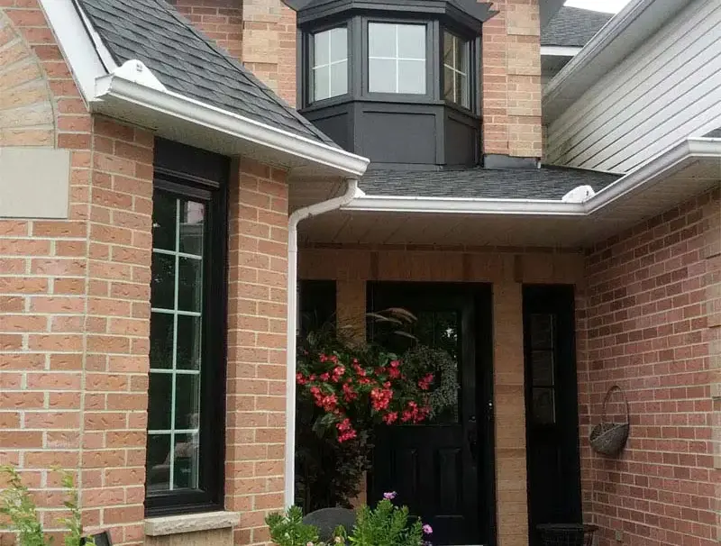 Black front door and windows on Ottawa brick home exterior