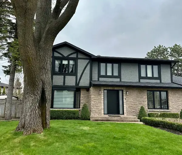 Ottawa Tudor-style home with black-trim windows and door